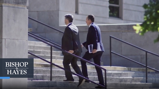 two attorneys walking up stairs outside